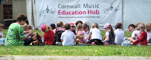 Photo taken at Hubbub event of children eating lunch in front of a Hub banner