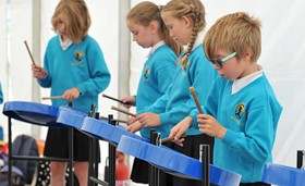 children playing jumbie jam steel pans