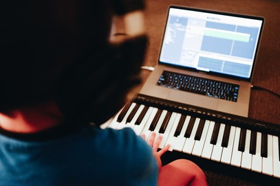 Picture of child with keyboard and laptop